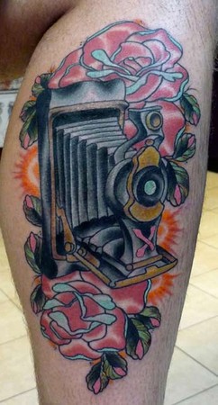 Colorful Movie Camera With Flowers Tattoo On Leg Calf