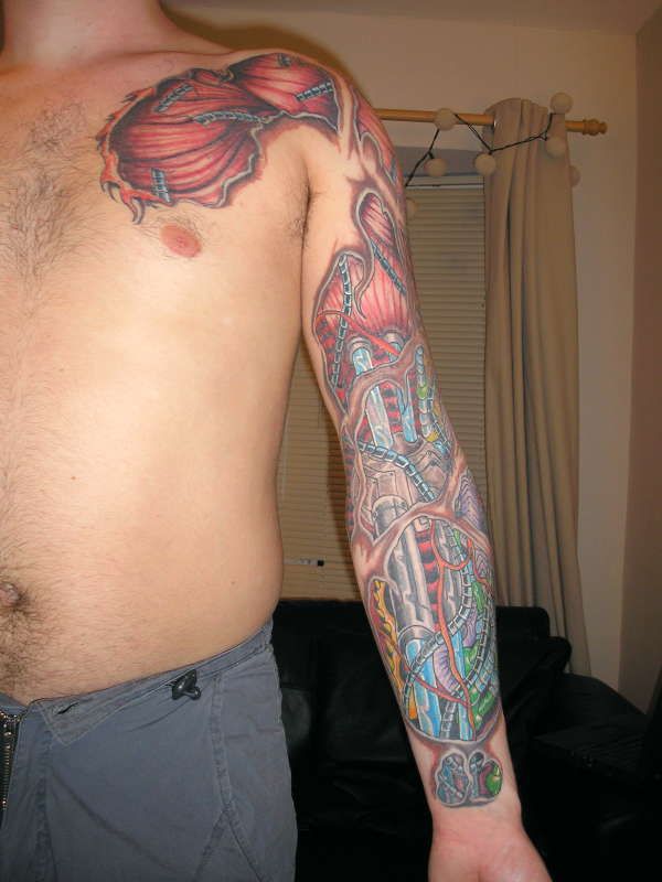 Colorful Ripped Skin Biomechanical Muscle Tattoo On Man Left Full Sleeve