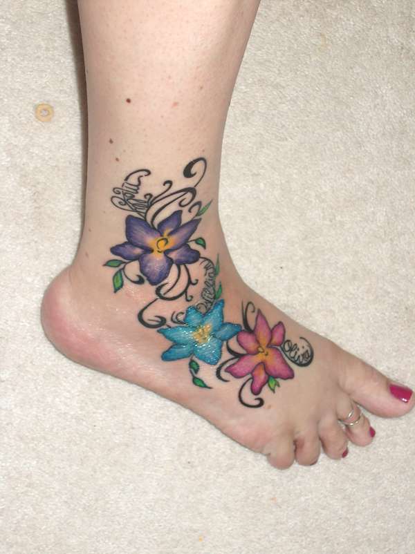 Colorful Three Flowers Tattoo On Girl Foot