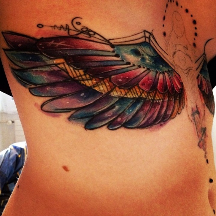 Colorful Wings Tattoo On Under Breast.