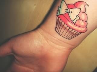 Cupcake With Bow Tattoo On Wrist