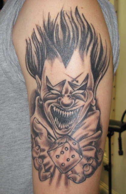 Dice In Clown Hand Tattoo On Man Left Half Sleeve