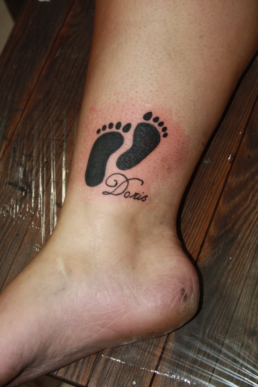 Doris - Black Feet Print Tattoo On Leg
