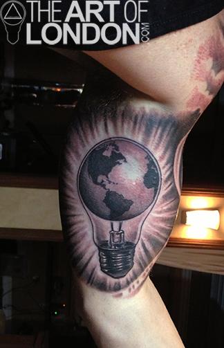 Earth In Bulb Tattoo On Inner Bicep