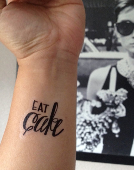 Eat Cake Lettering Tattoo On Wrist