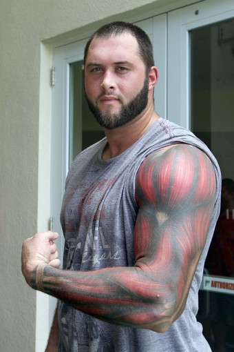 Fantastic Muscle Tattoo On Man Left Full Sleeve