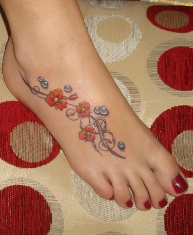 Flowers With Water Drops Tattoo On Girl Foot