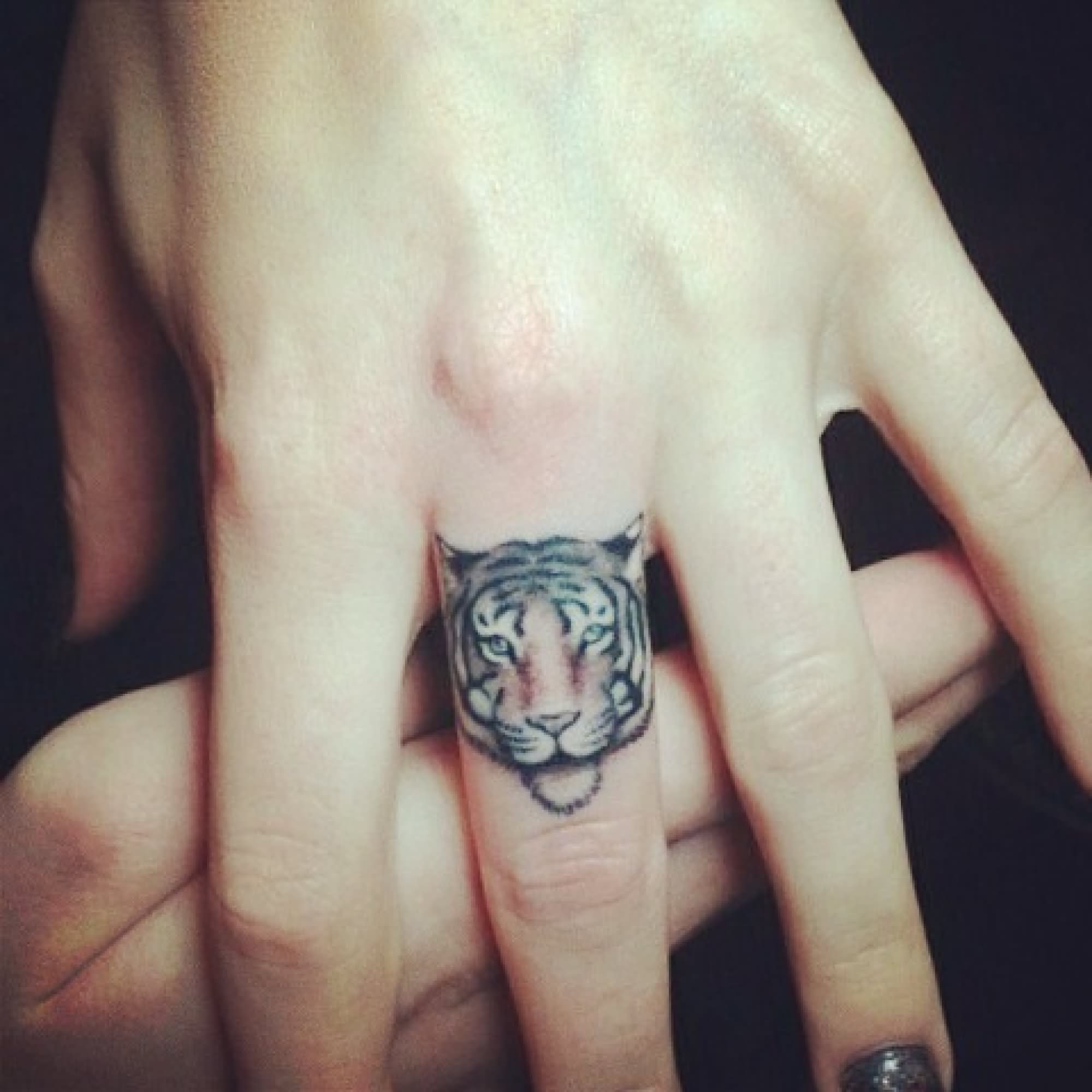 Girl Showing Her Cute Tiger Head Tattoo On Finger