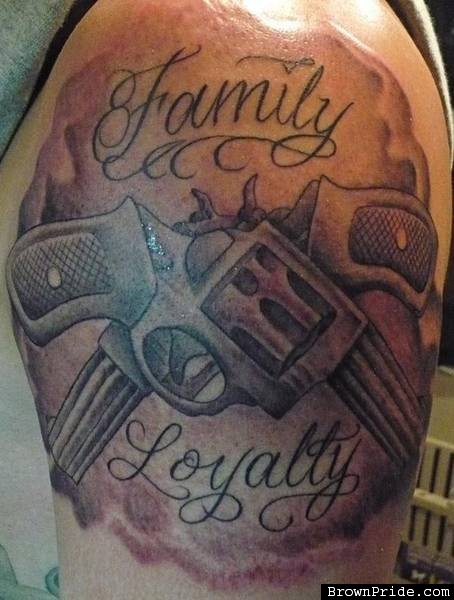 Grey Ink Guns And Family Loyalty Tattoo On Shoulder