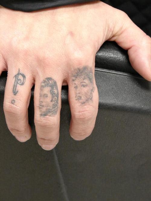 Grey Ink Portrait Tattoos On Fingers
