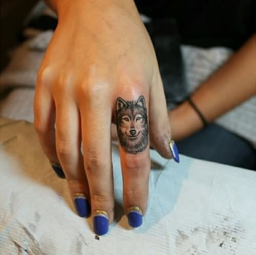 Grey Ink Wolf Head Tattoo On Girl Finger