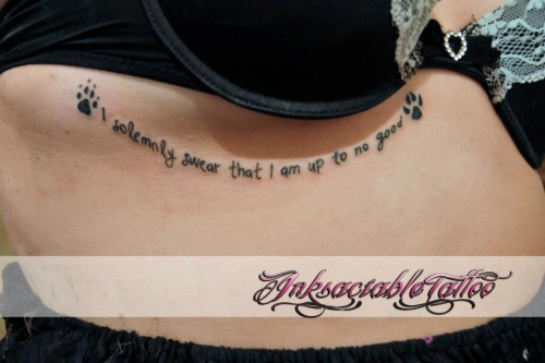 I Solemnly Swear That I Am Up To No Good Lettering With Paw Prints Tattoo On Under Breast