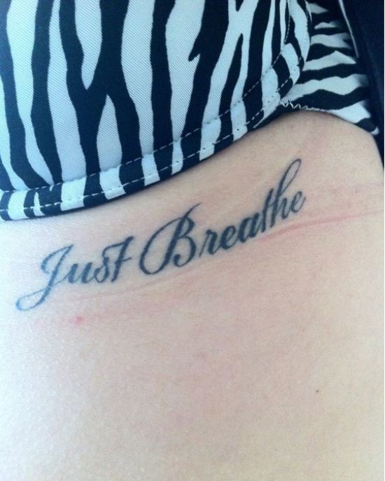 Just Breathe Lettering Tattoo On Under Breast