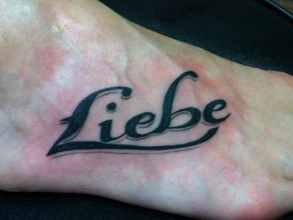 Liebe Lettering Tattoo On Foot