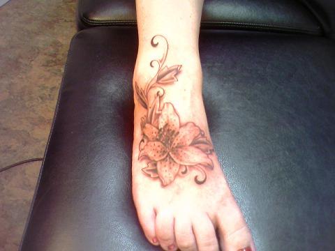 Lily Flower Tattoo On Girl Foot