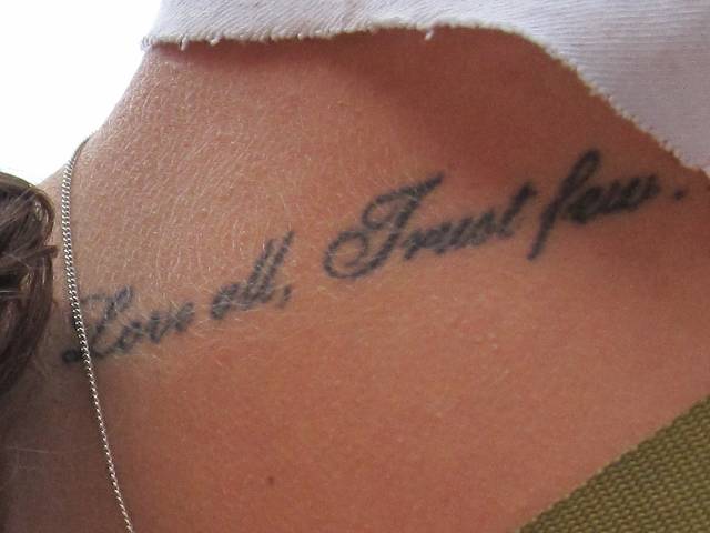 Love All Trust Few Tattoo On Upper Back