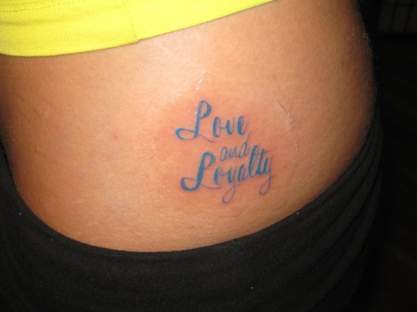 Love And Loyalty Tattoo On Lower Back