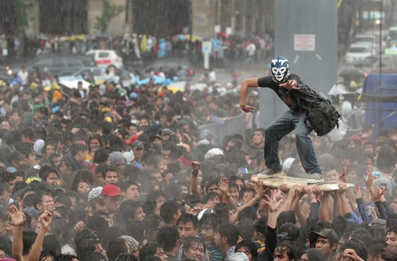 Man Surfing Over Crowd Funny Picture