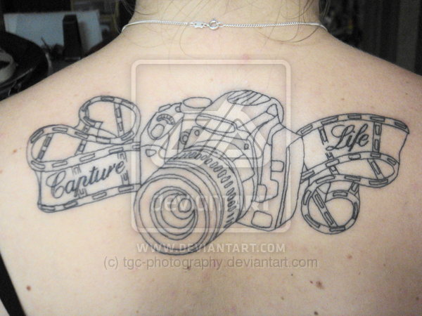 Movie Camera With Reel Tattoo On Girl Upper Back