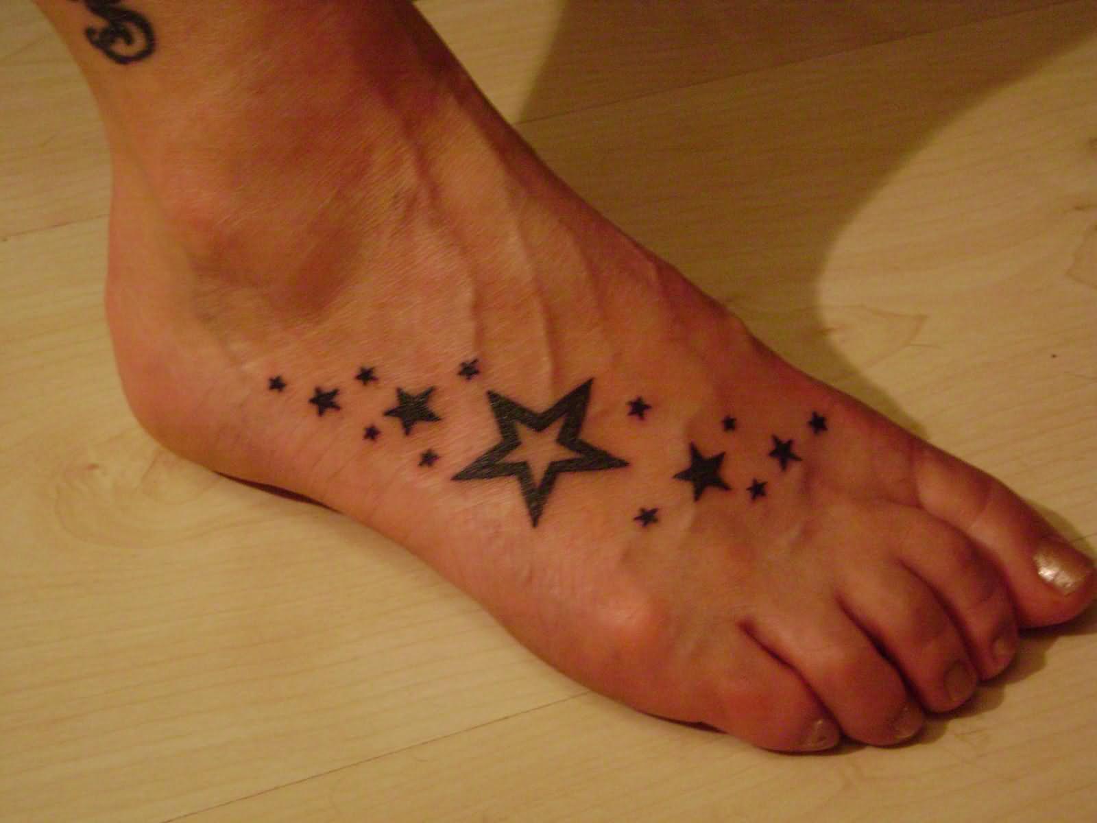 Nice Black Stars Tattoo On Foot