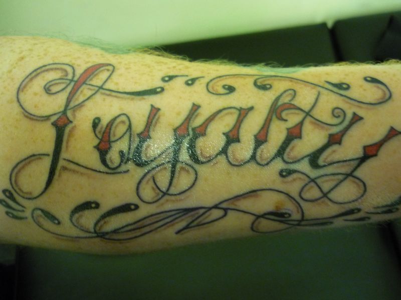 Red And Black Ink Loyalty Tattoo
