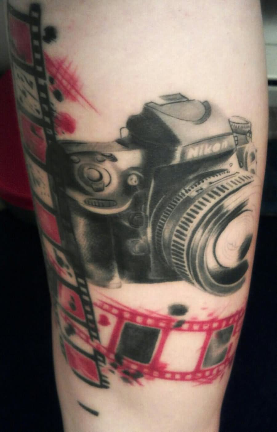 Red And Black Movie Camera With Reel Tattoo Design For Arm
