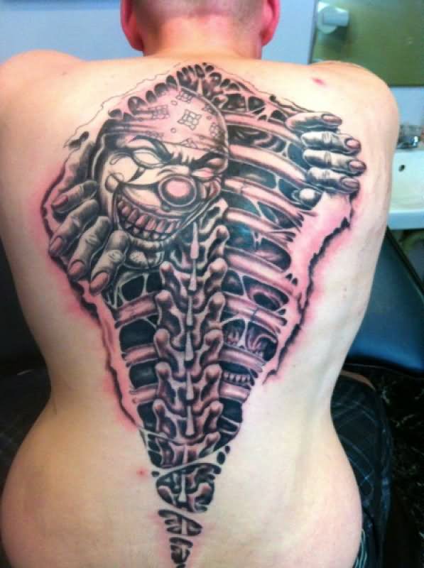 Ripped Skin Clown With Rib Cage Tattoo On Full Back