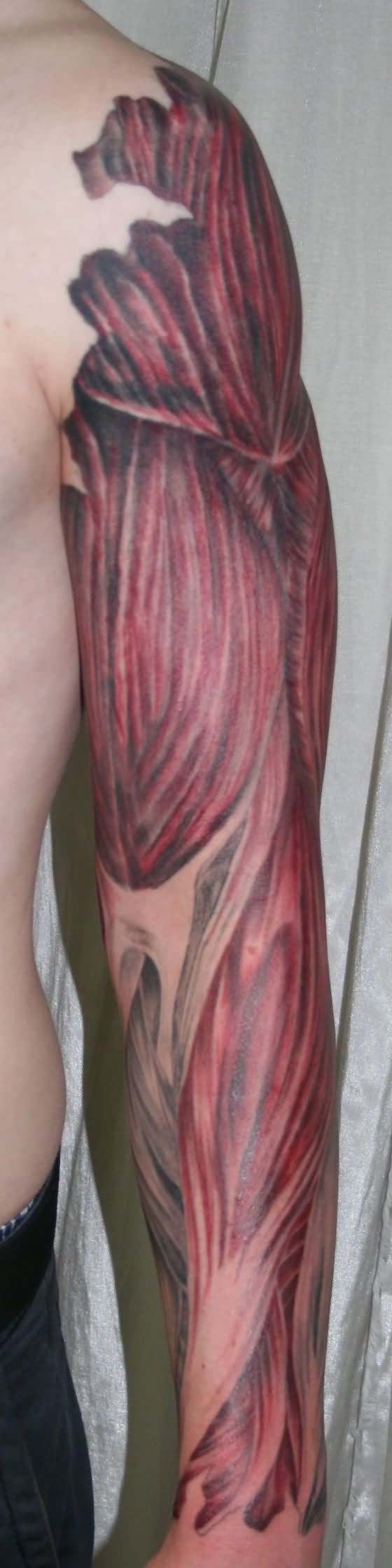 Ripped Skin Muscle Tattoo On Man Left Full Sleeve By 2Face