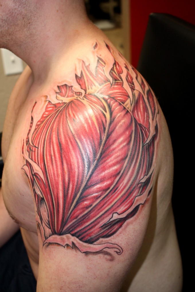 Ripped Skin Muscle Tattoo On Man Left Shoulder