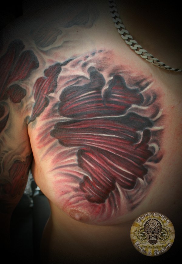 Ripped Skin Muscle Tattoo On Man Right Chest
