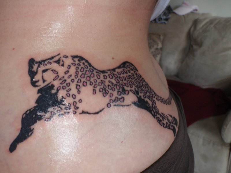 Running Cheetah Tattoo On Girl Lower Back