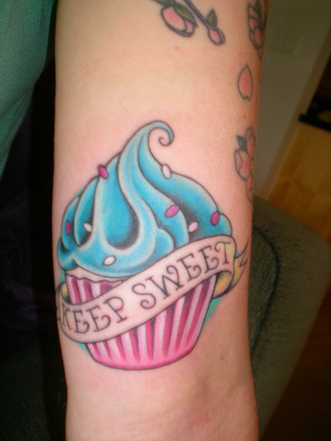 Simple Colorful Cupcake With Banner Tattoo Design For Bicep