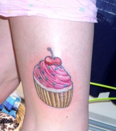 Simple Cupcake Tattoo On Girl Back Thigh