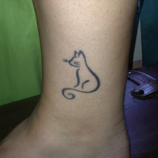 Small Outline Black Cat Tattoo On Ankle