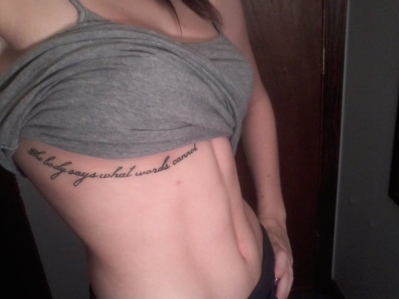 The Body Says What Words Cannot Lettering Tattoo On Under Breast