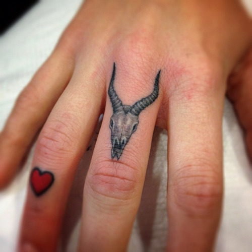 Tiny Red Heart And Animal Skull Tattoo On Finger