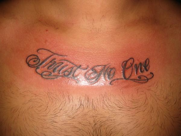 Trust No One Tattoo On Man Chest