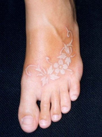 White Ink Flowers Tattoo On Foot