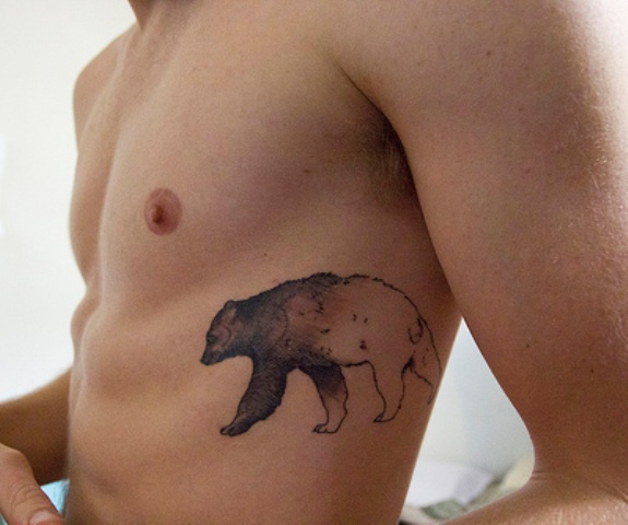 Wonderful Black Ink Bear Tattoo On Man Side Rib