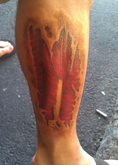 Wonderful Ripped Skin Muscle Tattoo On Leg