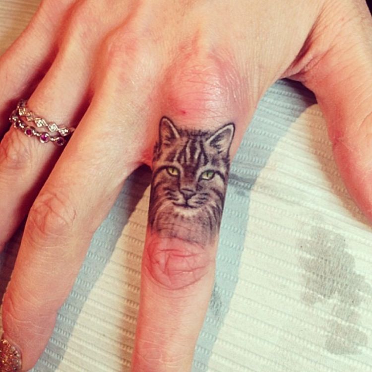 Yellow Eyes Cat Head Tattoo On Finger by Elizabeth Markov