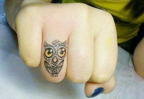 Yellow Eyes Owl Tattoo On Finger