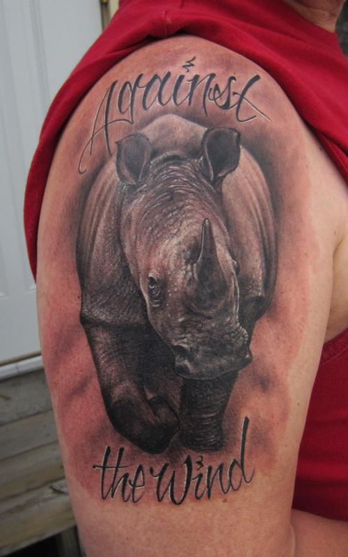 Against The Wind – Rhino Tattoo On Man Right Shoulder