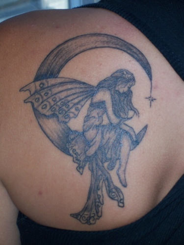 Black And Grey Fairy On Half Moon Tattoo On Left Back Shoulder