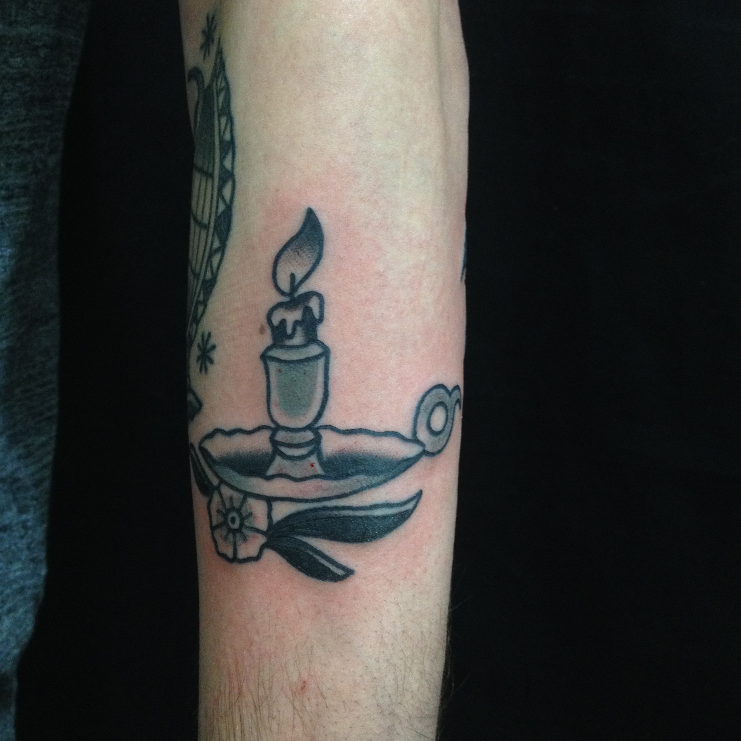Black Ink Burning Candle In Holder Tattoo On Arm