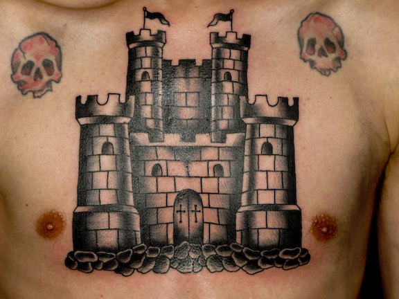 Black Ink Castle With Two Skull Tattoo On Man Chest