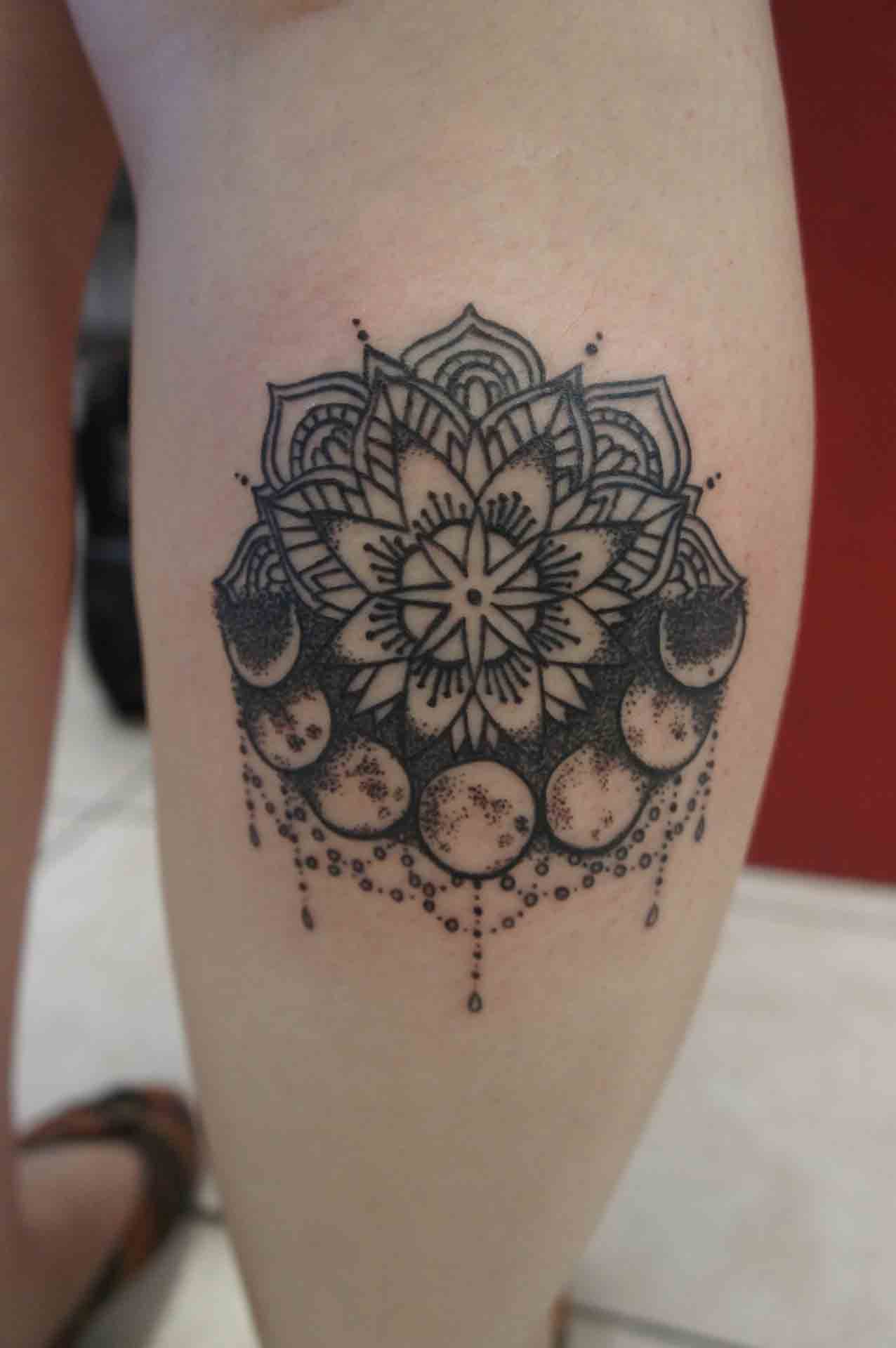 Black Ink Flower With Moons Tattoo On Leg Calf