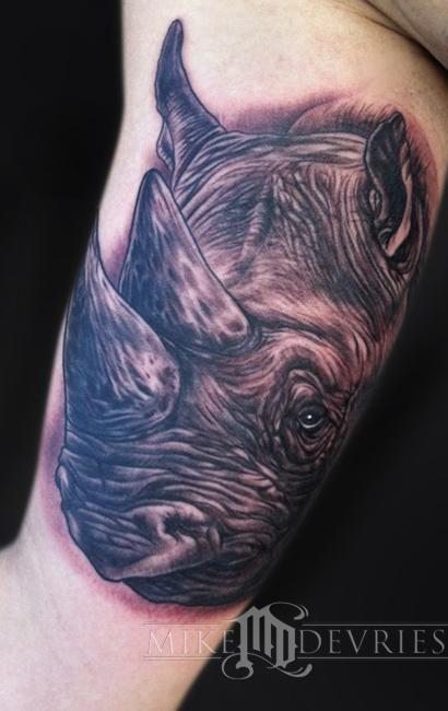 Black Ink Rhino Head Tattoo On Bicep By Mike Devries