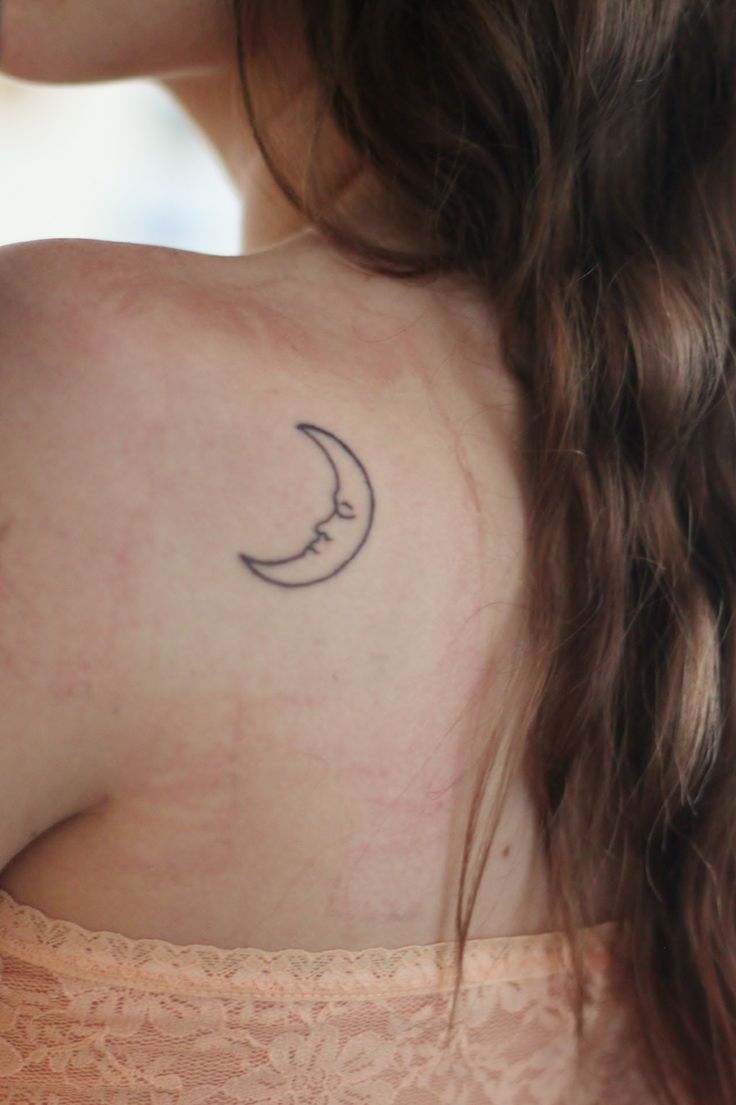 Black Outline Half Moon Face Tattoo On Girl Left Back Shoulder