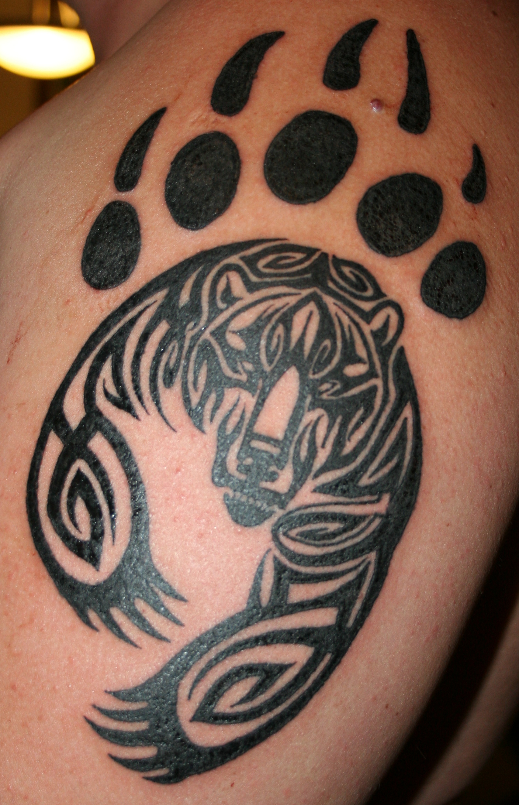 Black Tribal Bear With Paw Tattoo Design For Arm